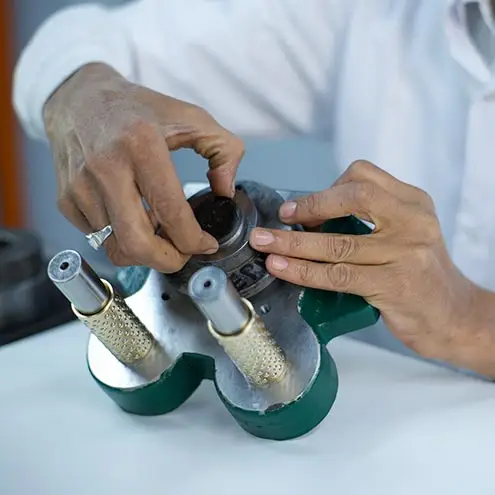 A technician working with precision tools to assemble watch components