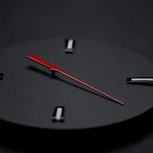 Minimalist black watch dial with a striking red second hand and metallic indexes